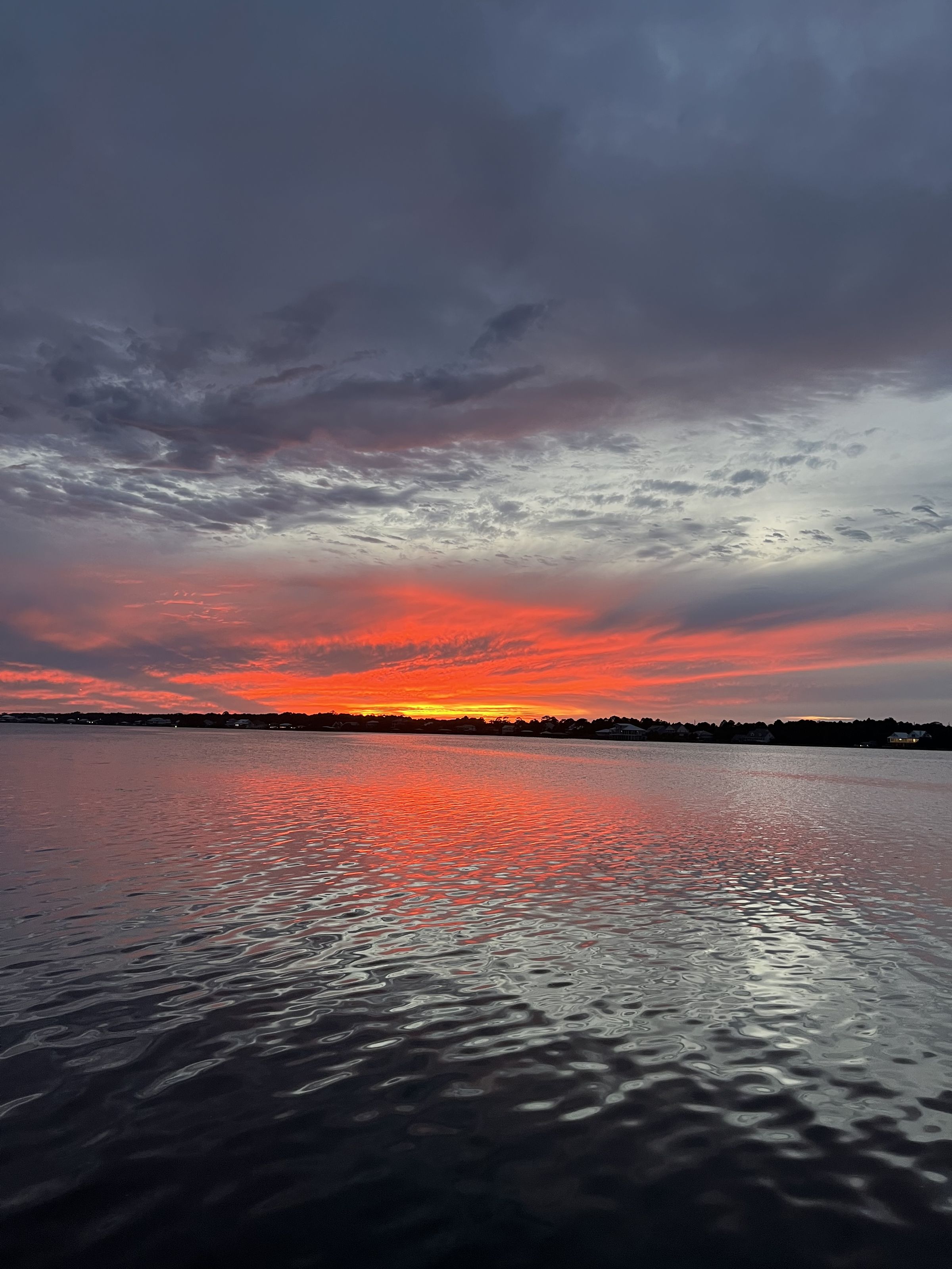 Burnt orange sunset reflecting across the lagoon at Heron's Hideaway, Gulf Shores, Alabama